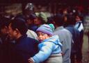 Father carrying baby.